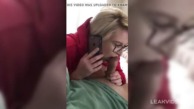 Cheating wife in glasses blowing young dude while on phone - 2 image