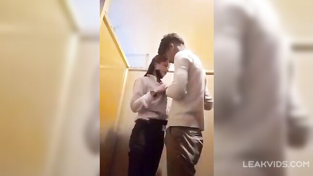 Pretty college girl with her boyfriend inside school washroom